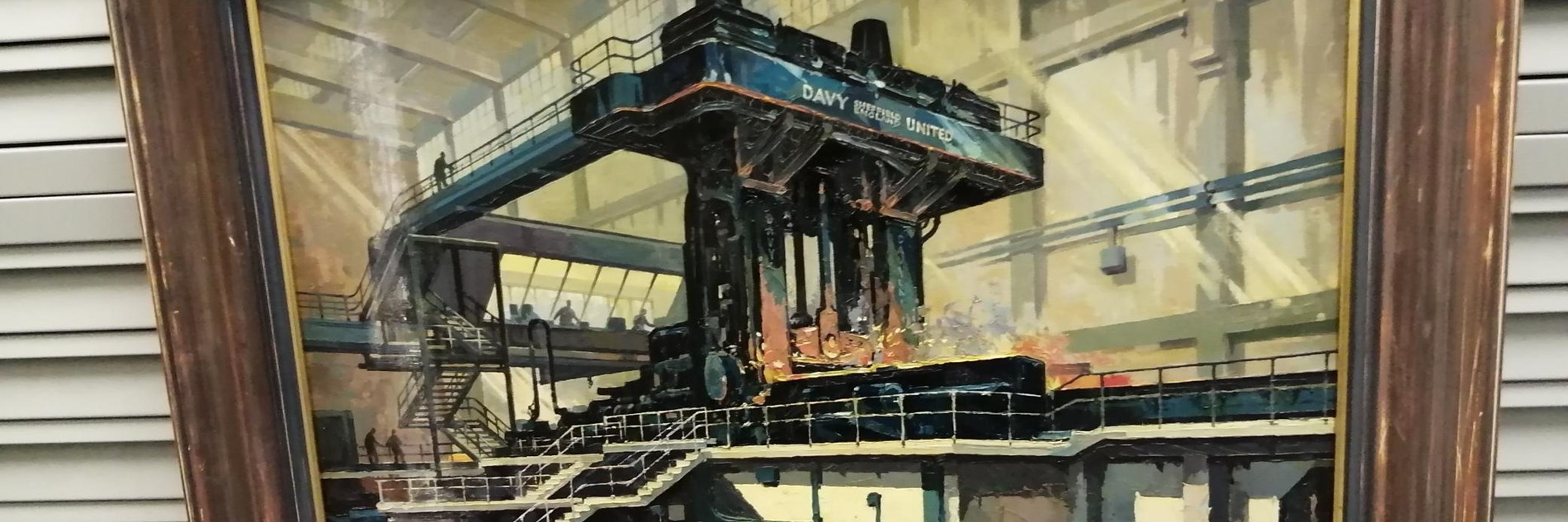 An oil painting depicting heavy industrial machinery at work. The painting is in a brown wooden frame.  