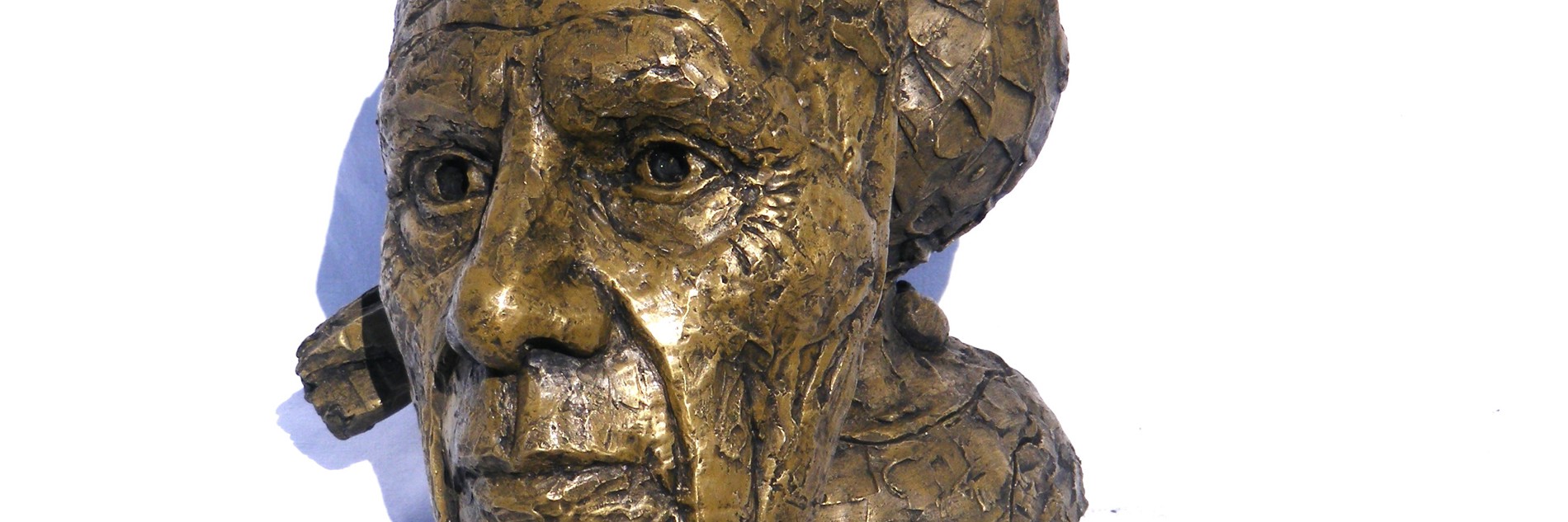 A photographs of a bust of Picasso, depicted with a bird on his head