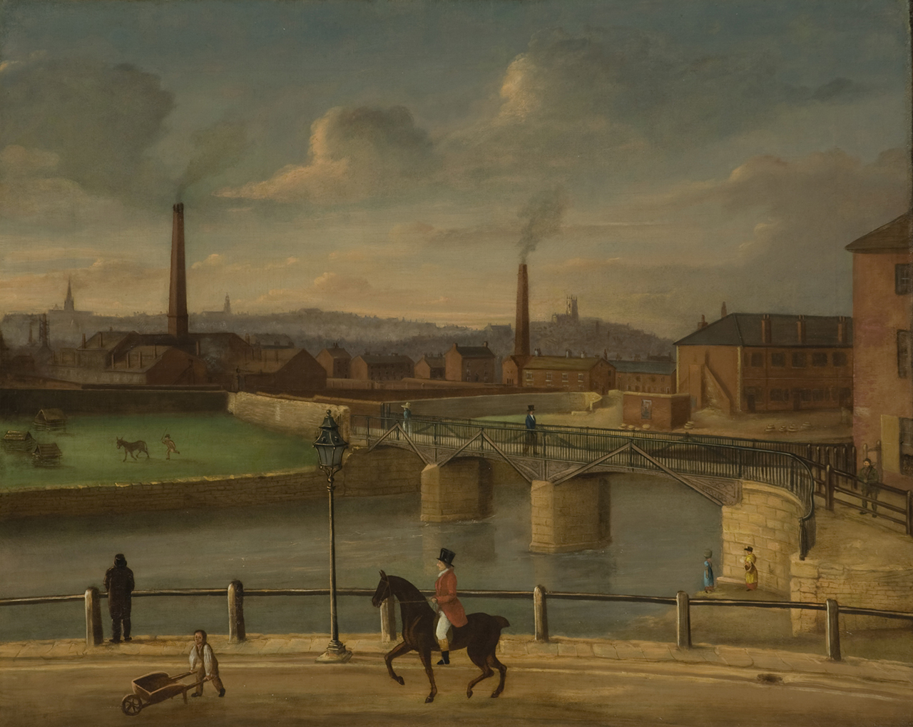 A large river or canal winds through an industrial landscape with smoking chimneys. In the foreground a figure in a red jacket, white jodhpurs and a black top hat rides a horse along a bridleway. On the left of the painting livestock can be seen grazing in a green field.