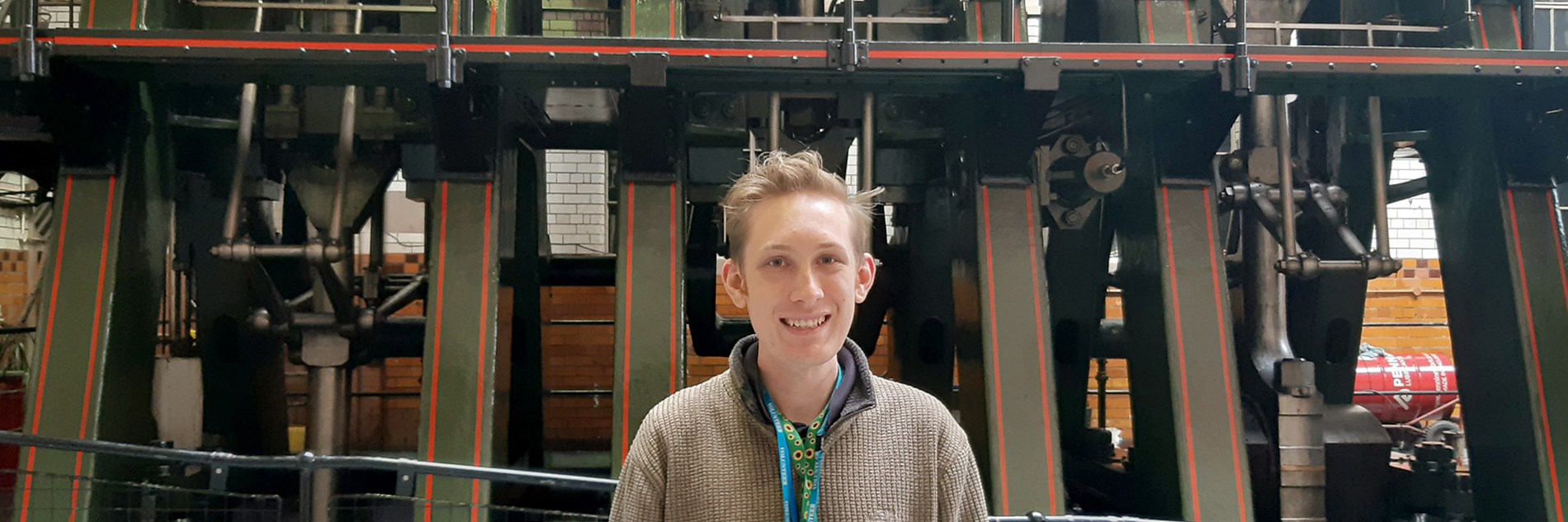 An adult standing in front of the River Don Engine