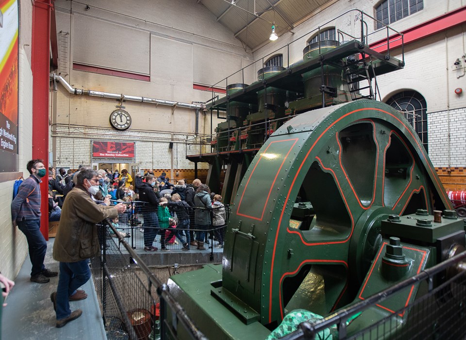 A group of adults and children looking at the River Don Engine. 
