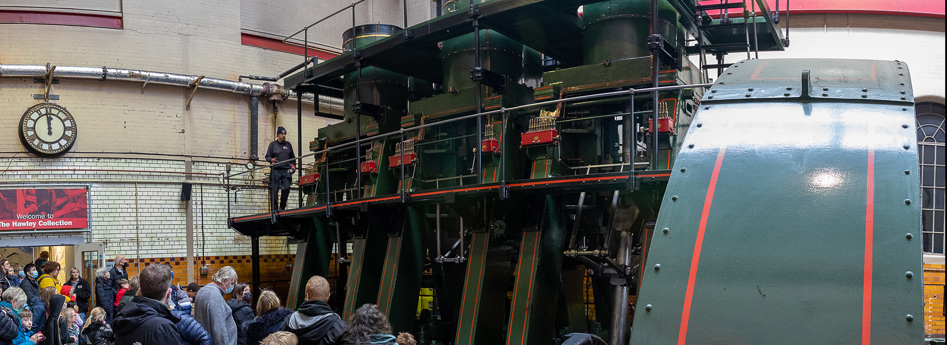 Large group of adults and children looking at the River Don Engine. 