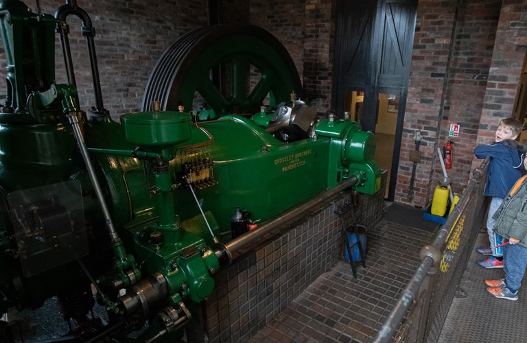 A restored working gas engine painted bright green 