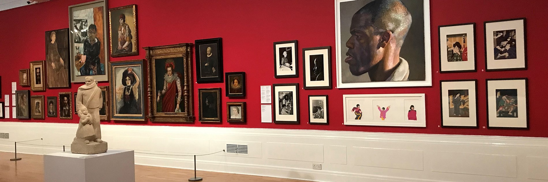 Contemporary and historical portraits on display in a gallery. 