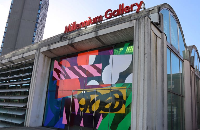 Exterior of Millennium Gallery featuring a bright, abstract design made from vinyl covering the window.