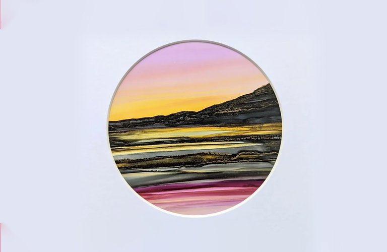 A landscape created with alcohol inks, using greens, reds and oranges.  The picture is mounted with a circular frame.