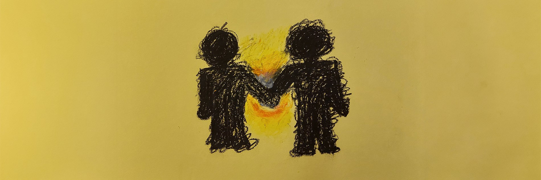 A crayon drawing on a yellow background of two figures in black silhouette holding hands. There joined hands are surrounded by yellow and orange.