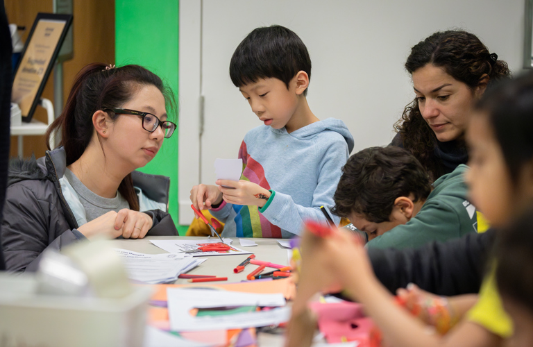 Children and adults taking part in craft activities.