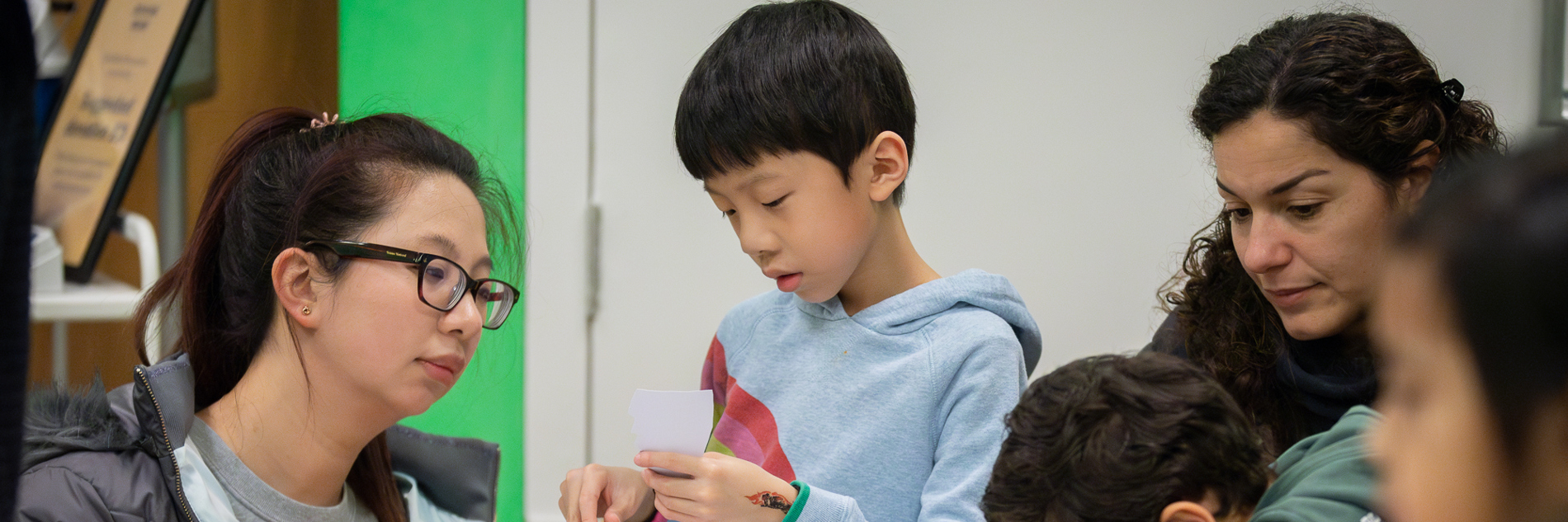 Children and adults taking part in craft activities.