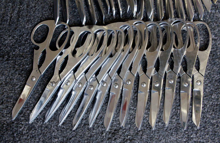 A photograph of 13 pairs of scissors 