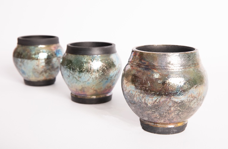 Three vases with a hammered, shiny surface. 