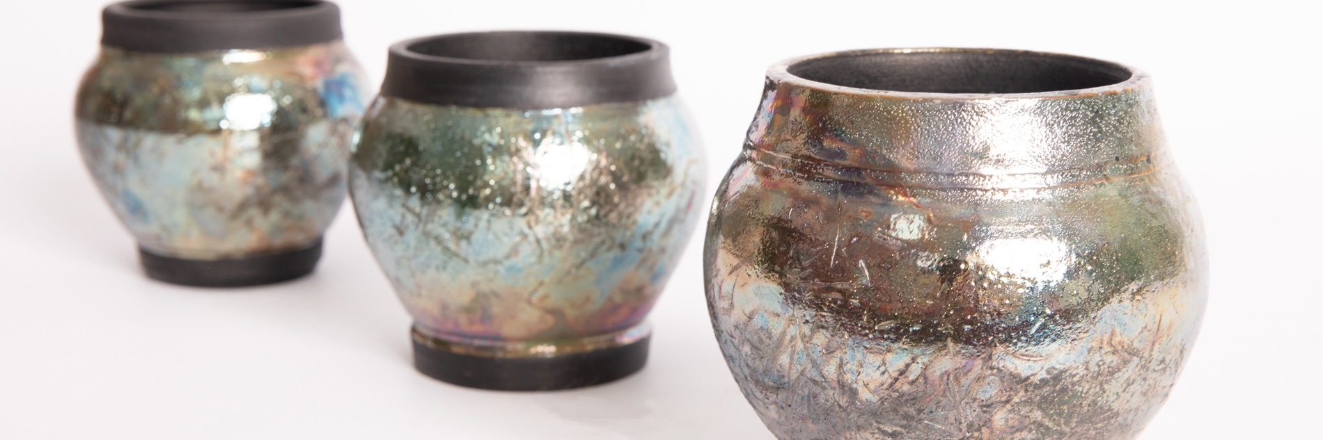Three vases with a hammered, shiny surface. 
