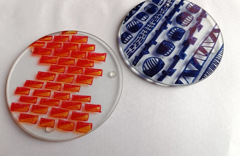 A photograph of decorated glass coasters. 