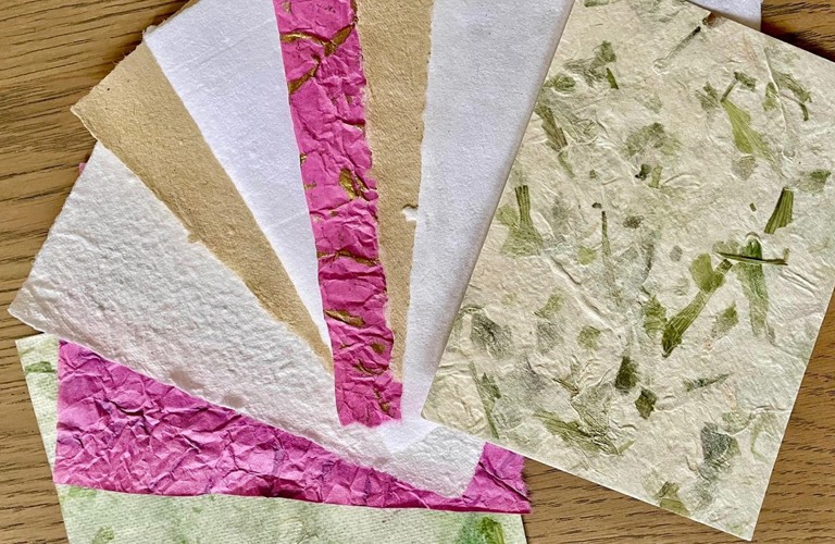 A photograph of handmade paper on a table. 