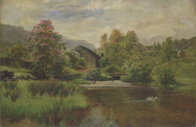 A rural scene showing a river run through green fields and trees. A stone building stands next to the river and a small bridge crosses it. A few further buildings stand on the hillside in the distance.