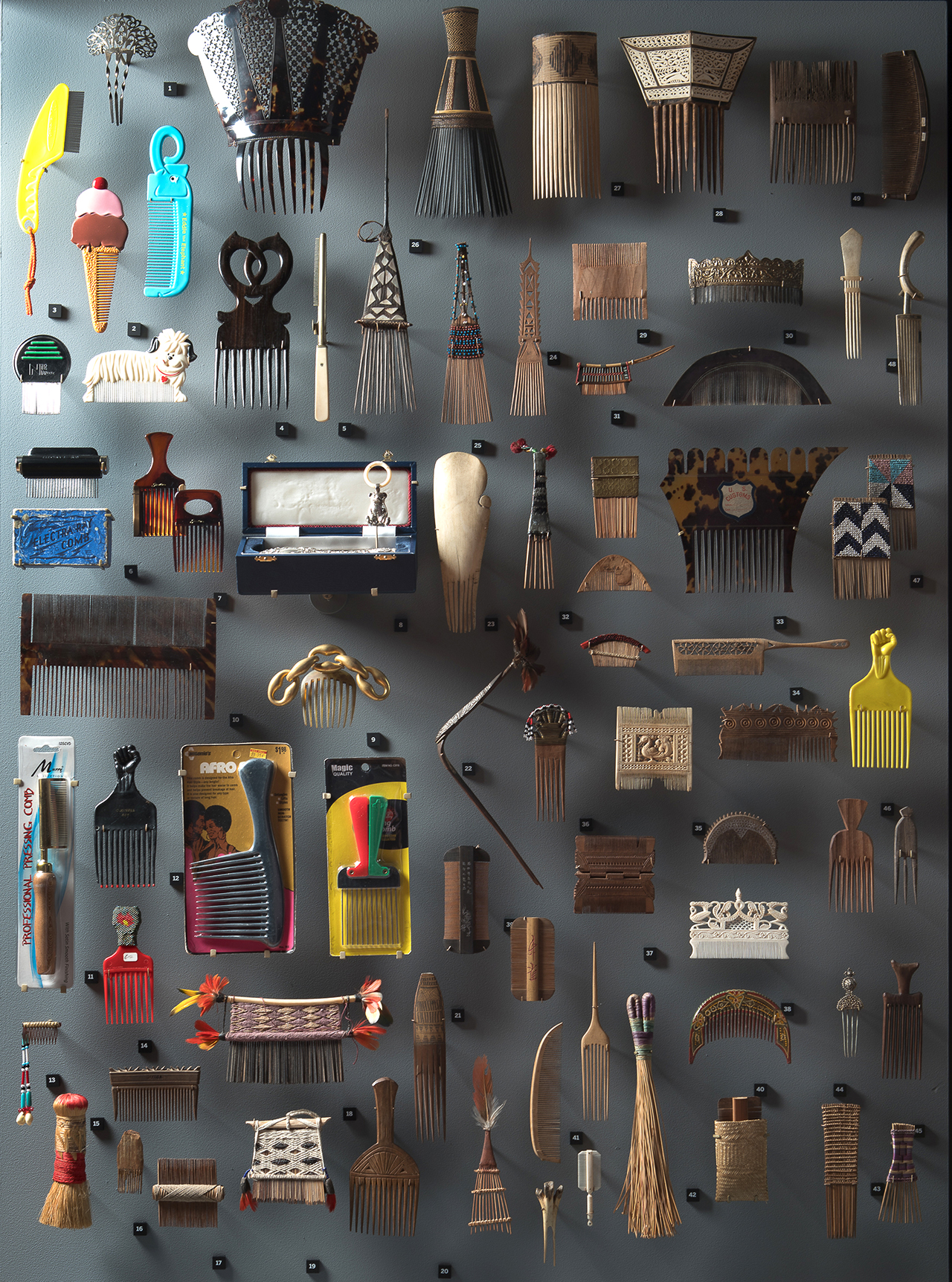 A photograph of a collection of historic and contemporary combs and brushes. 