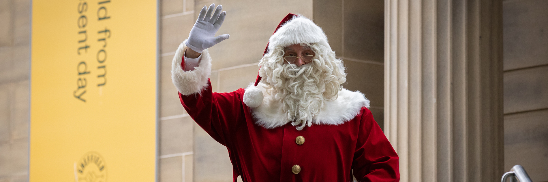A photograph of Santa waving outside of Weston Park Museum
