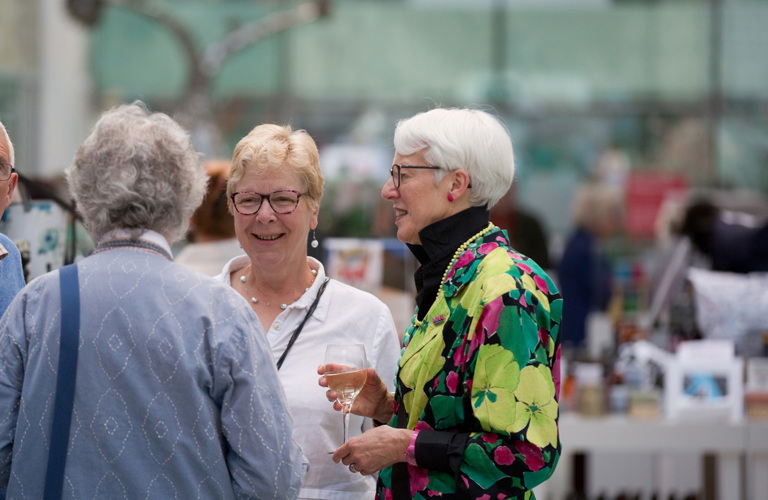 Three adults in conversation