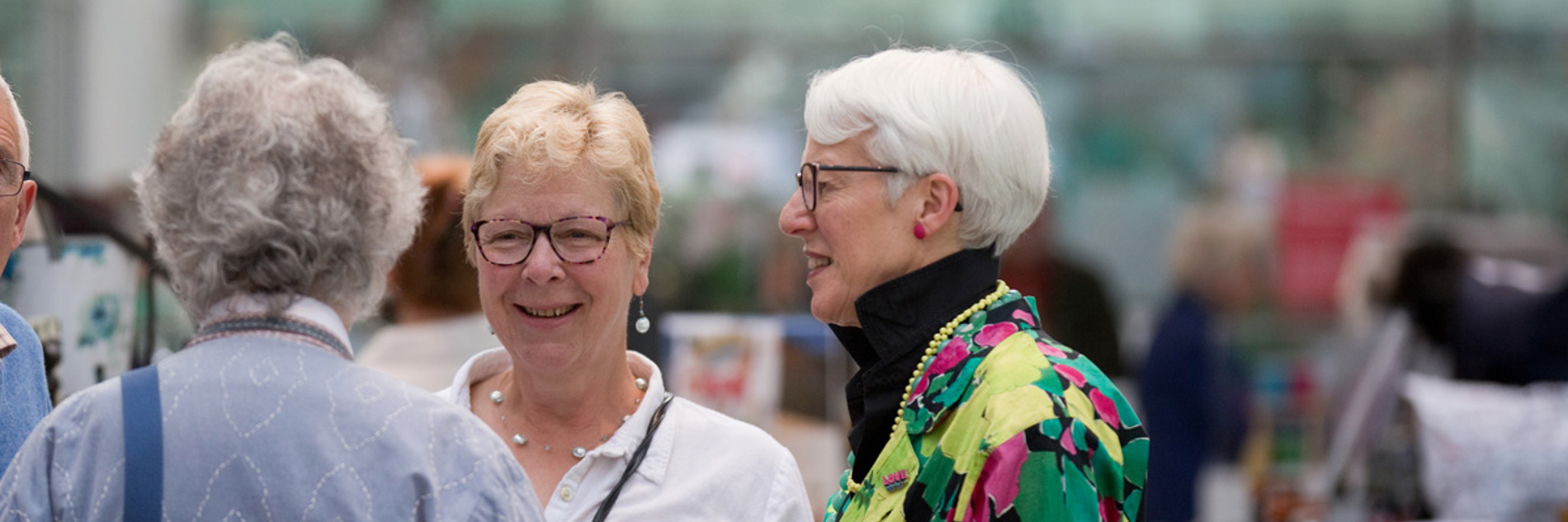 Three adults in conversation