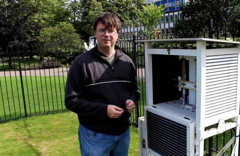 An adult outside in Weston Park, next to the Weather Station