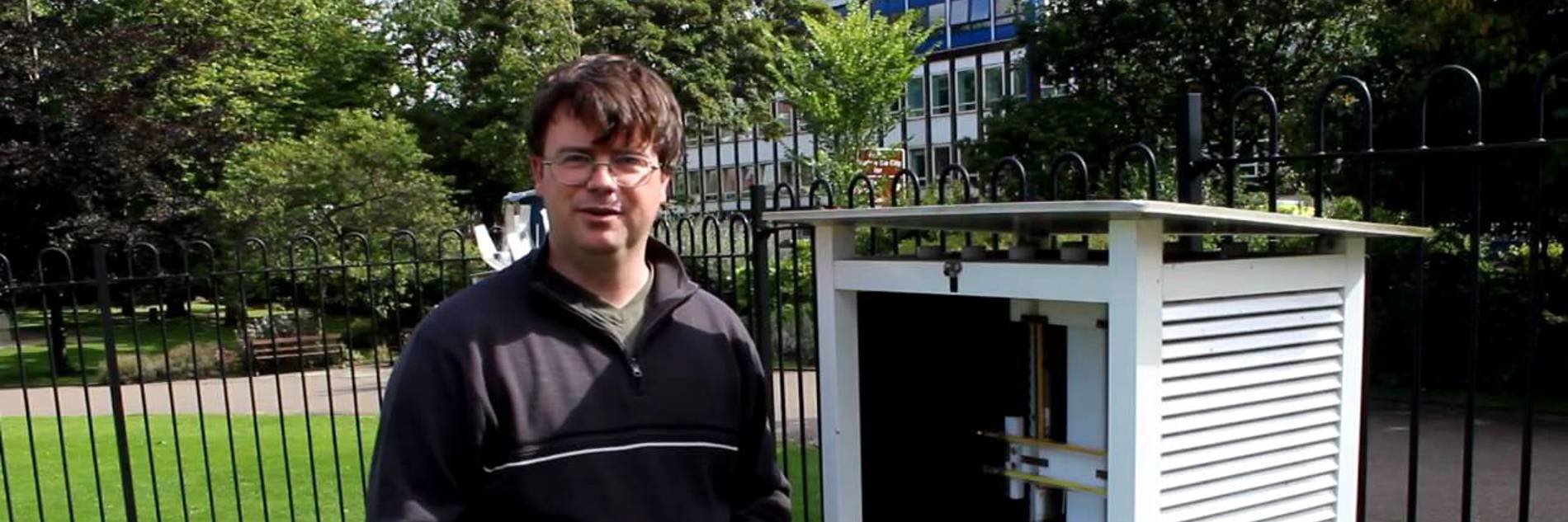 An adult outside in Weston Park, next to the Weather Station