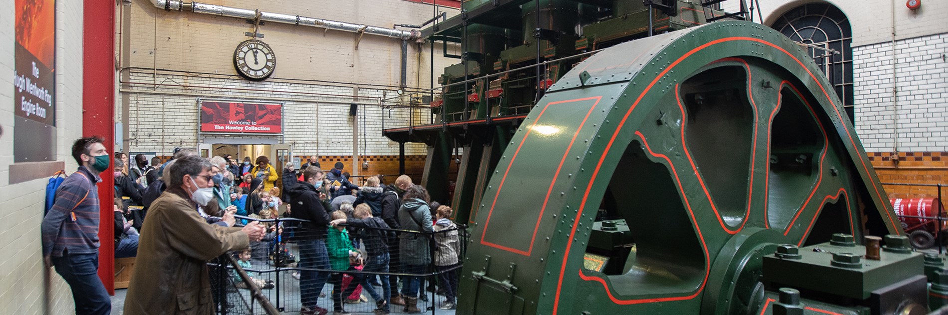 A group of adults and children looking at the River Don Engine. 