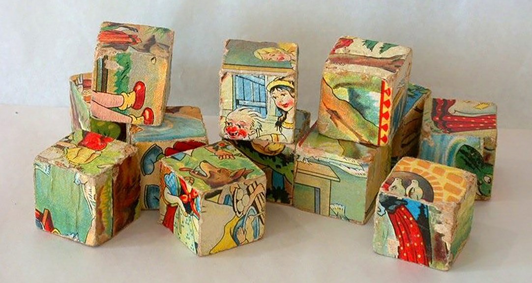 12 cube blocks, with sections of colourful illustrations of storybook type scenes on each side.