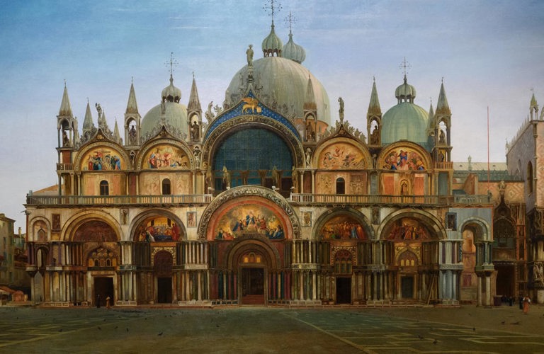 J.W.Bunney's painting Western Façade of the Basilica of San Marco, Venice. The basilica has many impressive golden arches and white domes, inspired by Islamic architecture. The square stretches out in front of, with only very few people depicted. The sky is blue at the top, but looks close to sunrise or sunset. 