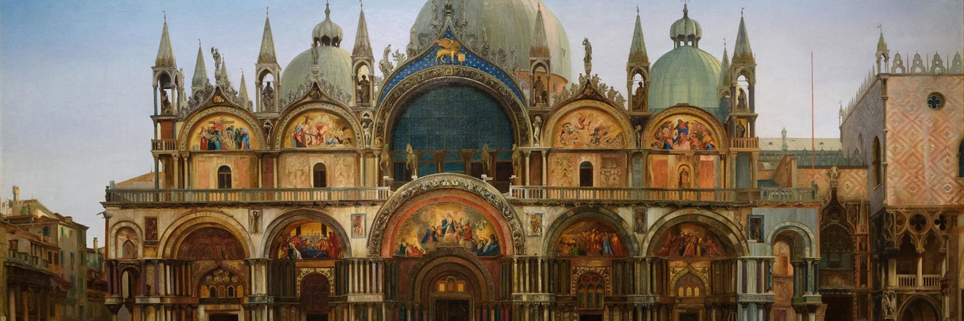 J.W.Bunney's painting Western Façade of the Basilica of San Marco, Venice. The basilica has many impressive golden arches and white domes, inspired by Islamic architecture. The square stretches out in front of, with only very few people depicted. The sky is blue at the top, but looks close to sunrise or sunset. 