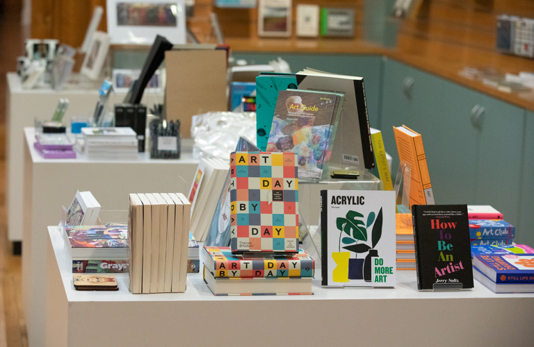 A museum shop display of art books and stationery items