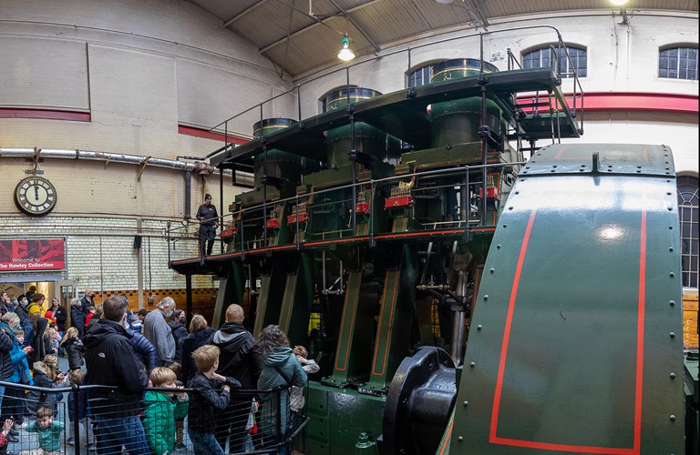 Large group of adults and children looking at the River Don Engine. 