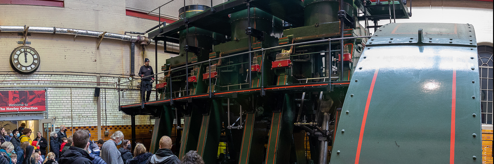 Large group of adults and children looking at the River Don Engine. 