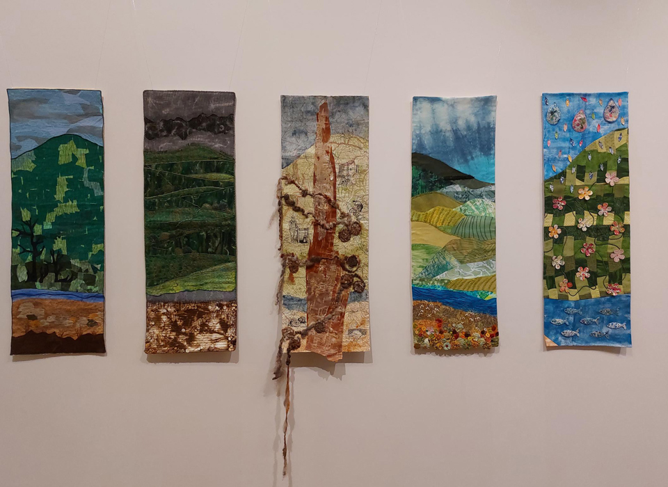A photograph of 5 textile banners 