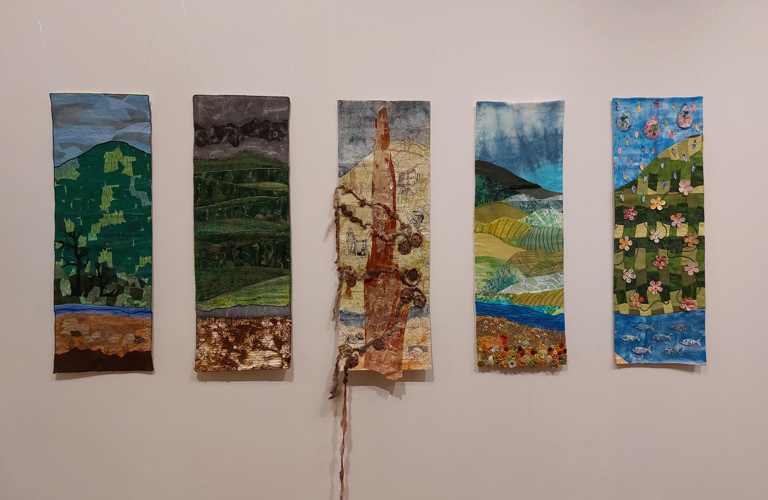 A photograph of 5 textile banners