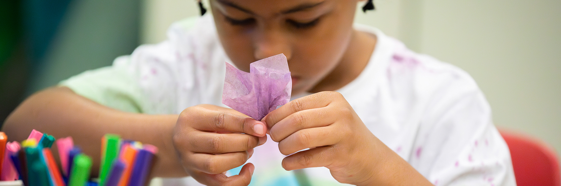 A child taking part in craft activities.