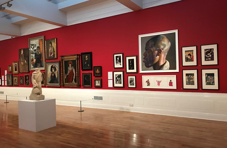 Contemporary and historical portraits on display in a gallery. 
