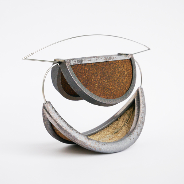 A contemporary metal brooch, with geometric lines.