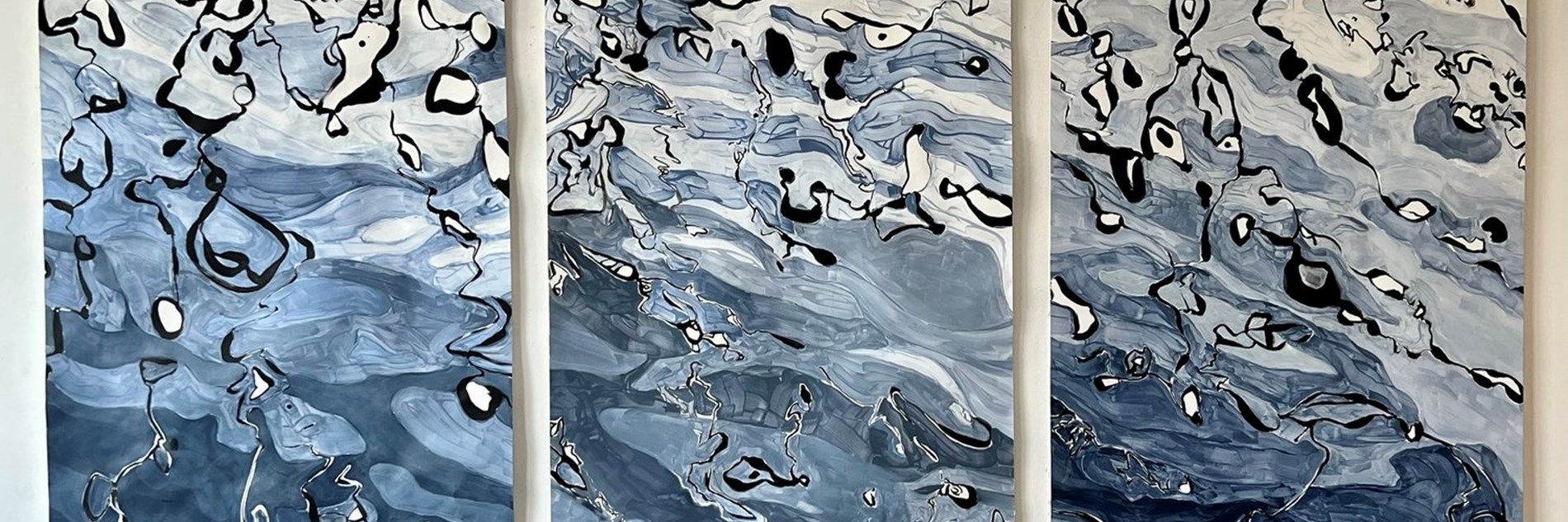 A monochrome painting in black, blue, grey and white of reflections on the surface of eater. The painting is made of up of three portrait sections to form a landscape format triptych. 