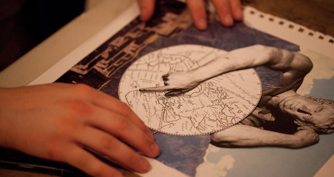 A pair of hands arranging material in a collage, including a map, a photograph of a skyscape and an image of a historic statue.