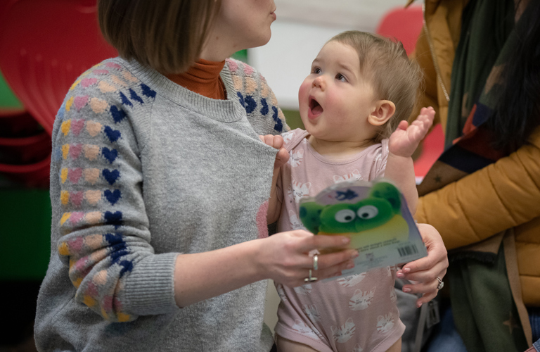 A photograph of a baby looking an adult.