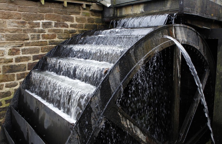 A waterwheel with water running over it.