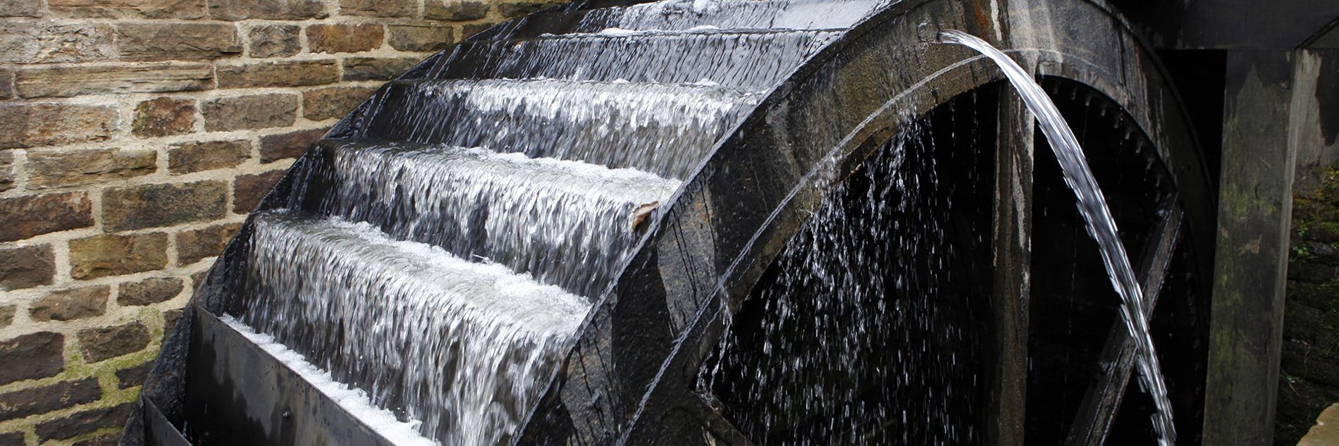 A waterwheel with water running over it.