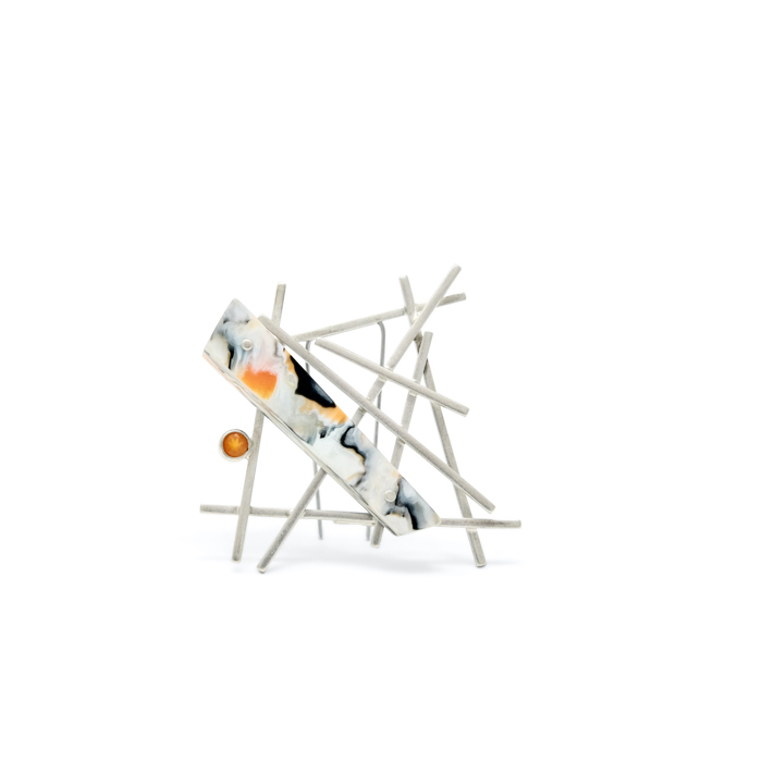 A photograph of a geometric brooch against a white background. 