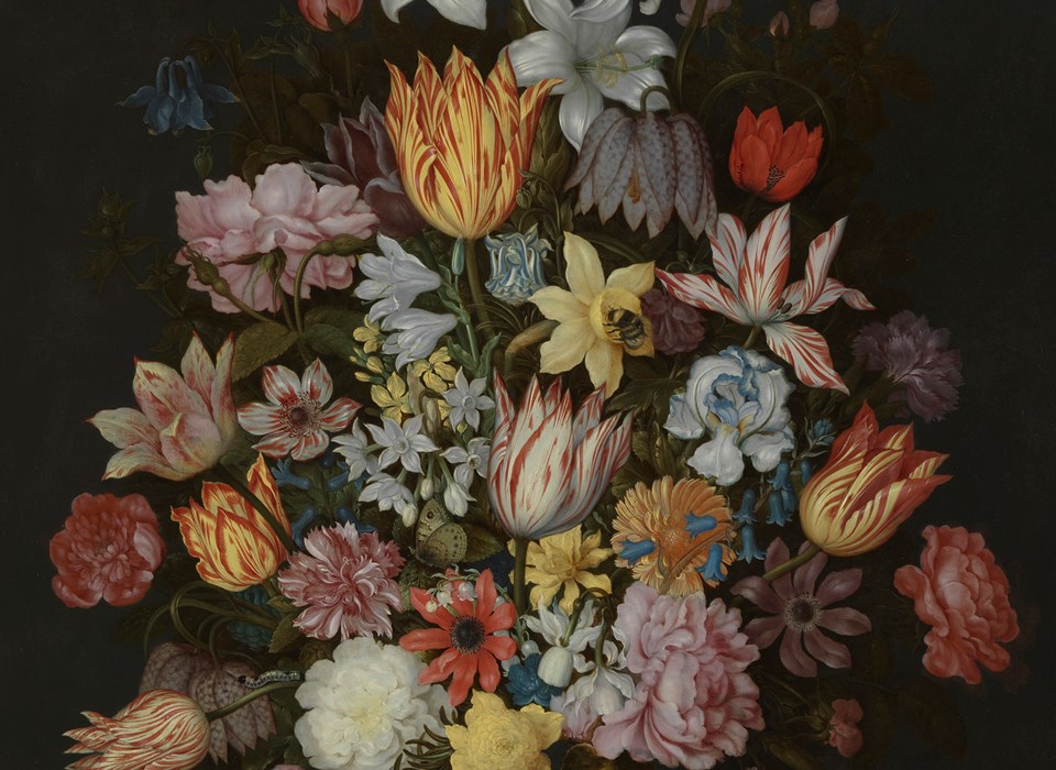 An arrangement of white, yellow, red, pink and orange flowers in a vase decorated with a blue and white image of a bird in foliage. Next to the vase is a cutting from a plant with a pink flower, a butterfly three shells and some flower petals.