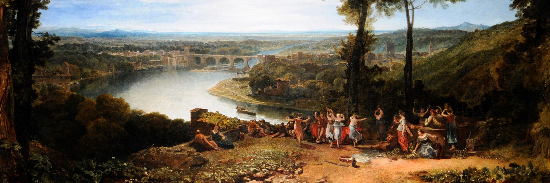 An oil painting of a rural landscape on a sunny day. In the foreground figures dance and celebrate on a hillside.  In the background there is a river, trees, buildings and a bridge, with mountains in the distance. 