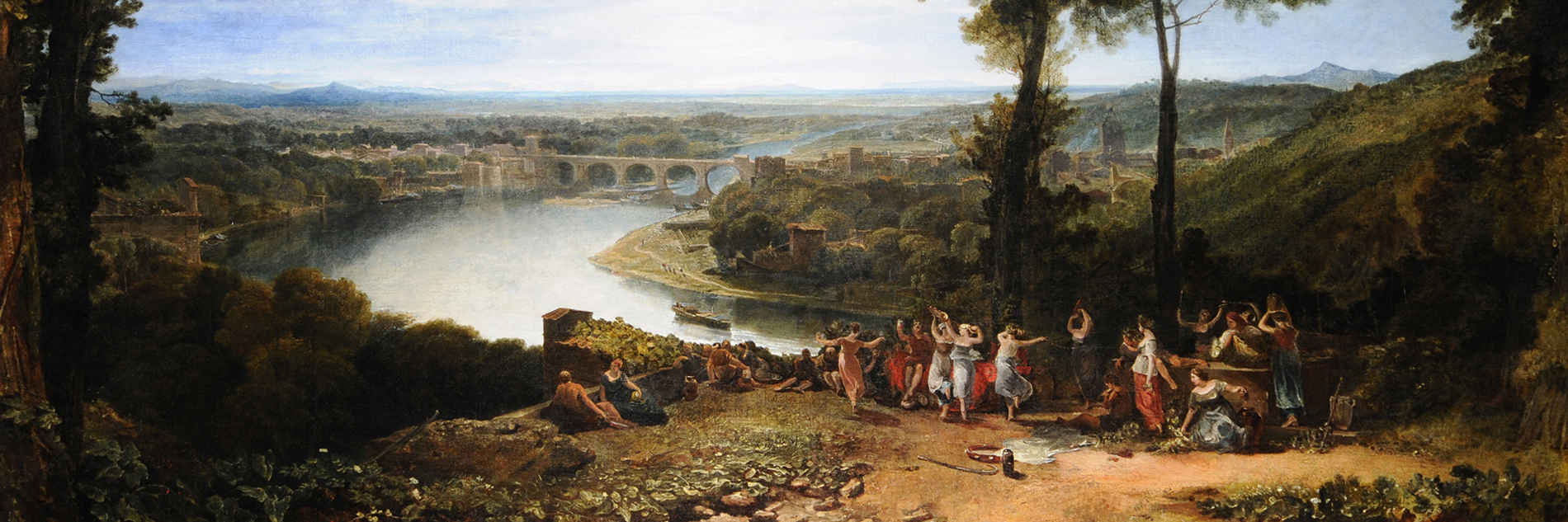 An oil painting of a rural landscape on a sunny day. In the foreground figures dance and celebrate on a hillside.  In the background there is a river, trees, buildings and a bridge, with mountains in the distance. 